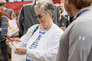 A community member looking at her Honor swag | Honor Credit Union