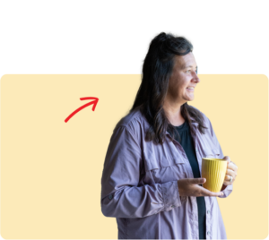 women holding a cup of coffee looking off in the distance | Honor Credit Union