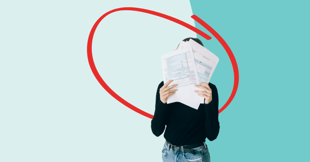 women holding tax documents in front of her face