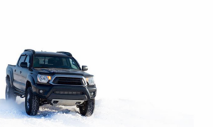 black truck driving in the snow | Honor Credit Union