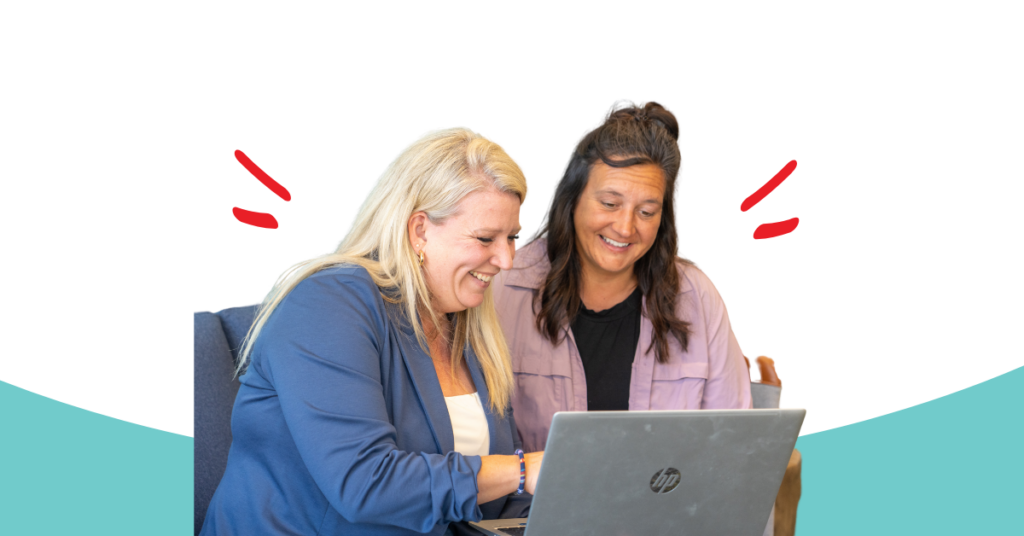 Honor team member helping an Honor member on a laptop