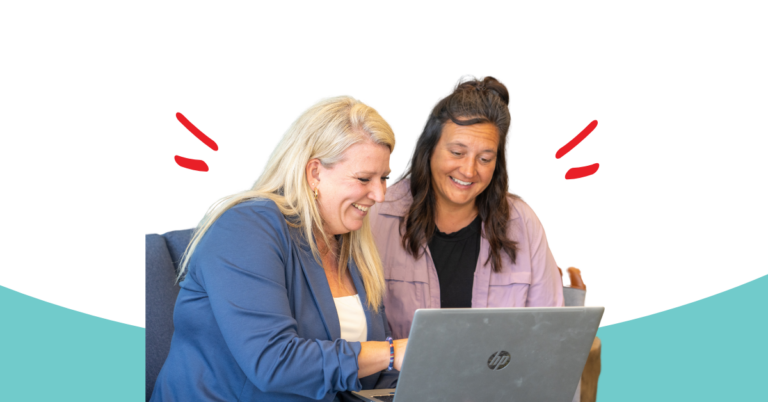 Honor team member helping an Honor member on a laptop