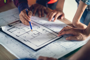 Architect and Engineer working drawing document about project planning and progress of work schedule on the home building construction | Honor Credit Union