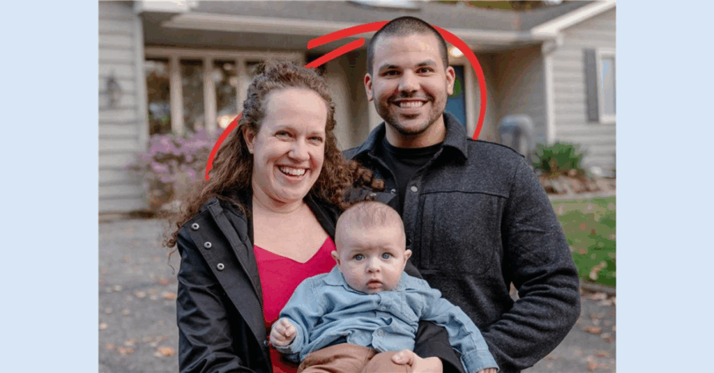 A photo of a husband and wife holding a baby