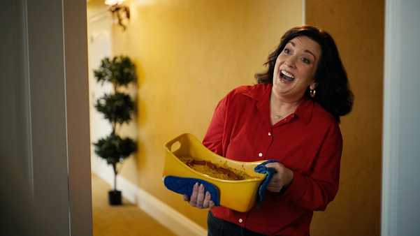 friendly Honor employee with a casserole