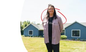 homeowner in front of her new house | Honor Credit Union