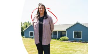 homeowner in front of her new house | Honor Credit Union