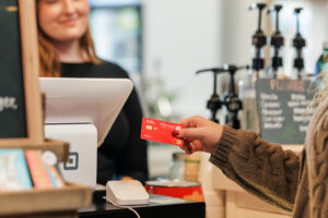girl paying with Honor debit card | Honor Credit Union