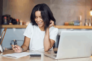 businesswoman looking at paperwork at a desk | Honor Credit Union