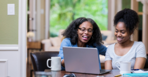 college student with her mother looking at a laptop | Honor Credit Union