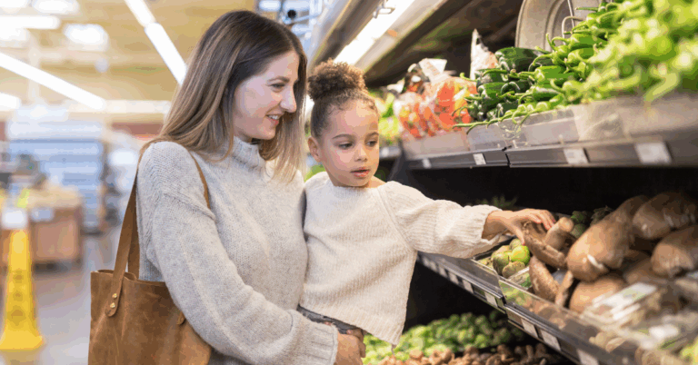 mother grocery shopping with her young daughter