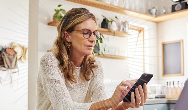 women using online banking on her cell phone