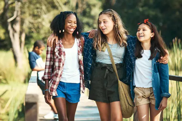 group of girls smiling and laughing outside