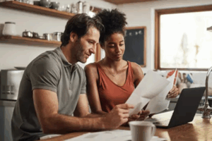 man and woman looking at paperwork at a table | Honor Credit Union