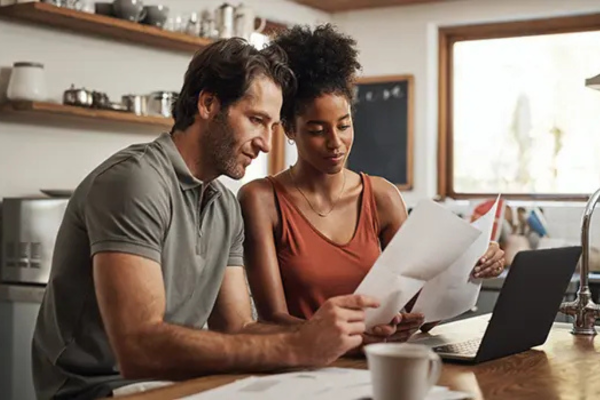 man and woman looking at paperwork at a table