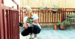women doing painting her deck | Honor Credit Union
