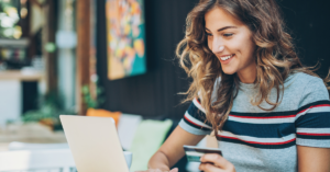 women with her credit card on her laptop | Honor Credit Union