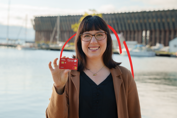 An Honor member holds up a debit card