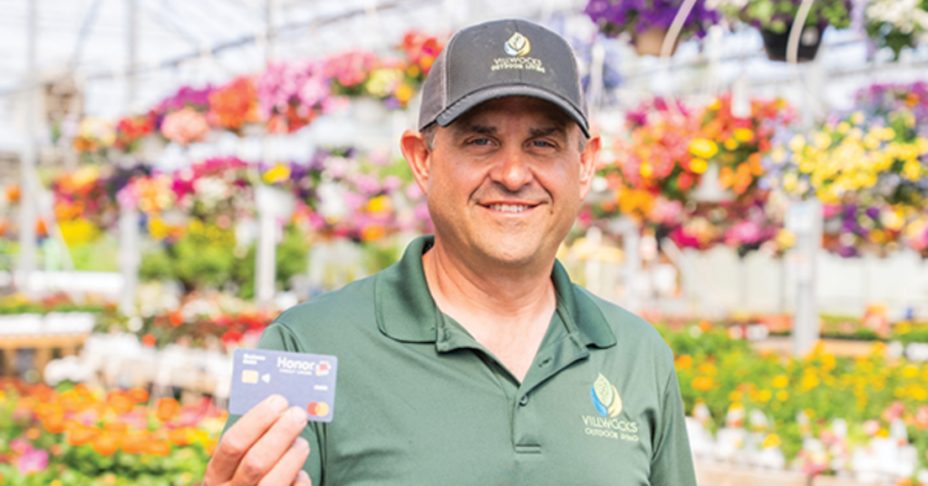Business owner holding an Honor Business Credit Card | Honor Credit Union