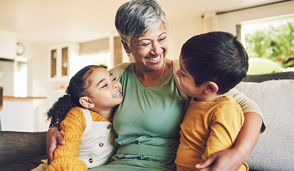 grandmother with her arms around her grandchildren