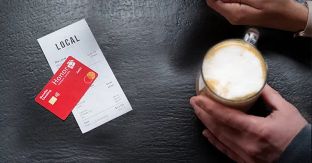 honor card on top of a receipt and a cup of coffee