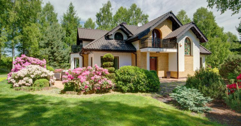 two story house with flowers in the yard