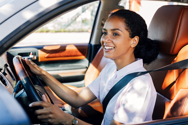 Young adult women driving a car.