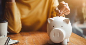 putting change in a piggy bank | Honor Credit Union