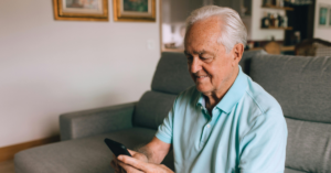 senior man looking at his cell phone | Honor Credit Union