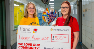 Teachers holding a large Honor check for Teacher Awards | Honor Credit Union
