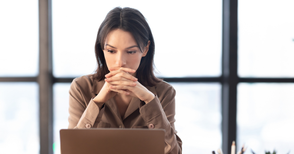 women looking at laptop concerned | Honor Credit Union