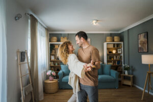 Happy husband and wife dance at home | Honor Credit Union