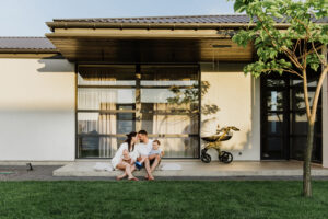 A young family with two sons in the yard of their own house | Honor Credit Union