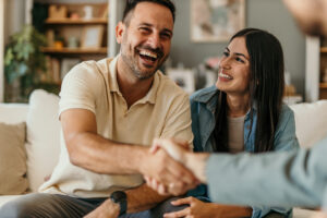 The young happy couple and an agent in a new property handshaking | Honor Credit Union