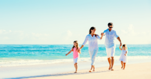 Family walking on a beach on vacation | Honor Credit Union