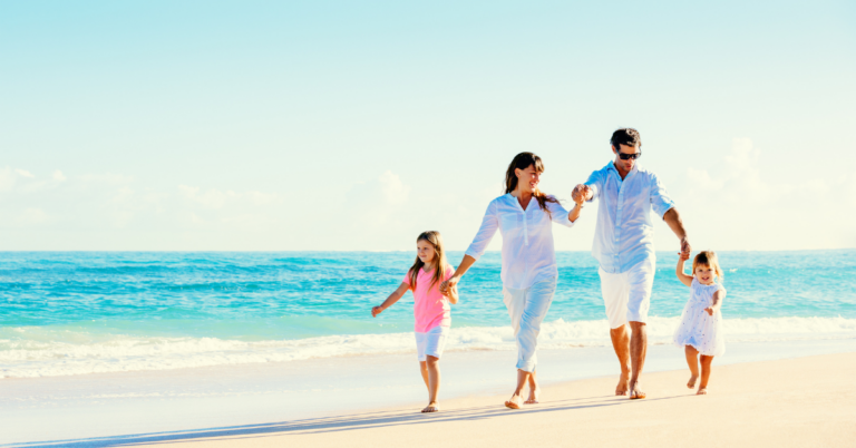 Family walking on a beach on vacation