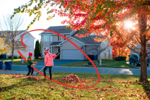 Family raking leaves in front of their home | Honor Credit Union