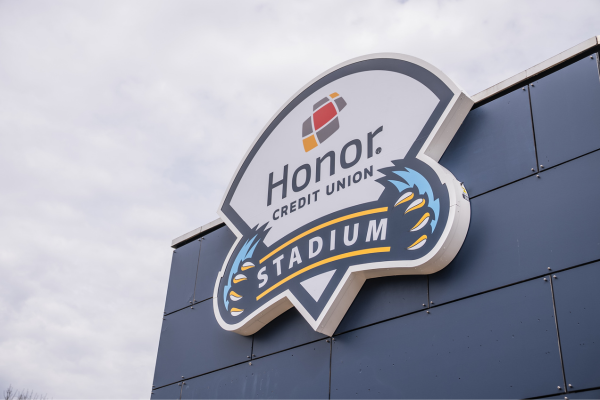 Honor Credit Union Stadium sign mounted on a dark blue building façade. | Honor Credit Union | Honor Credit Union
