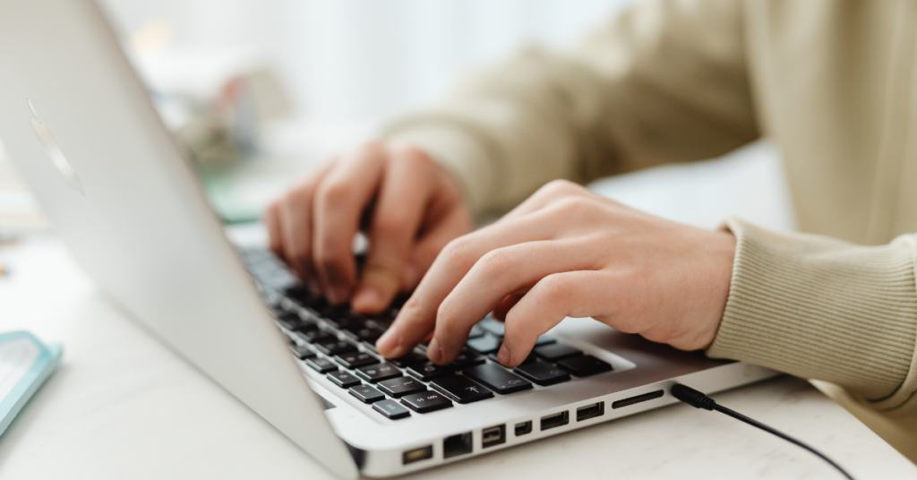 close up of hands typing on laptop | Honor Credit Union