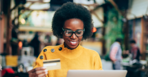 women using her credit card shopping on her laptop | Honor Credit Union