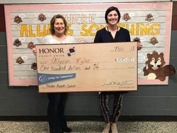 Honor's Karol Behrle presenting Eau Claire Public School's Allyson Rigler with $100 Teacher Award