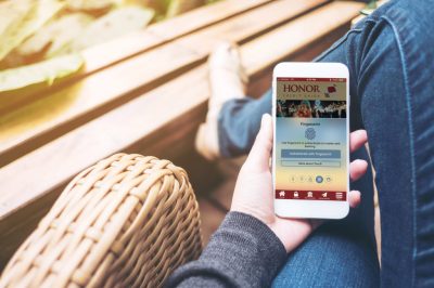 women sitting on chair using phone (honor app_ women sitting on chair using phone (honor app_